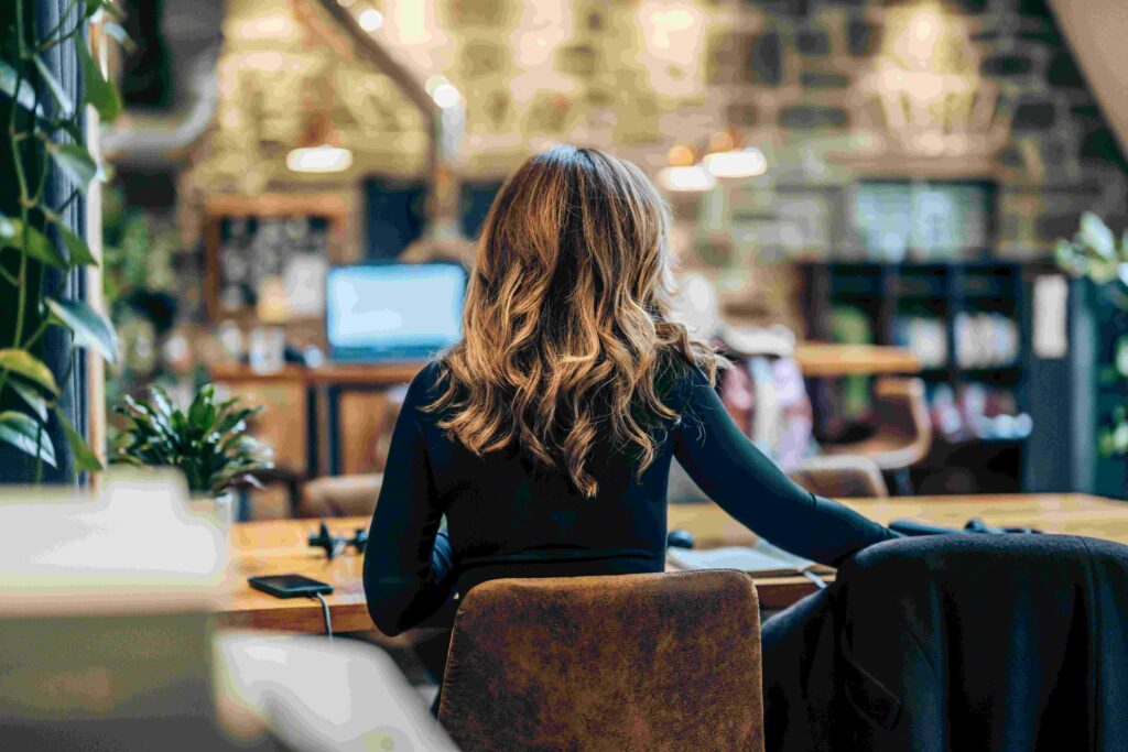 Woman with back to us, working at a desk