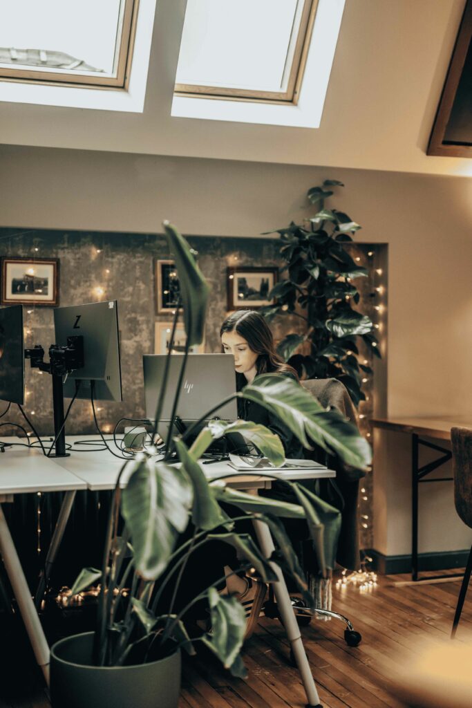 Woman working at computer in coworking space
